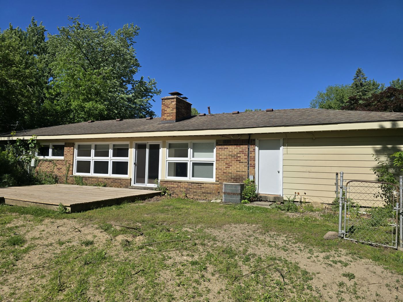 Rear of a brick ranch home during an exterior inspection